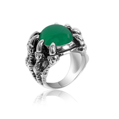 Ring med en klo som håller om en grön sten